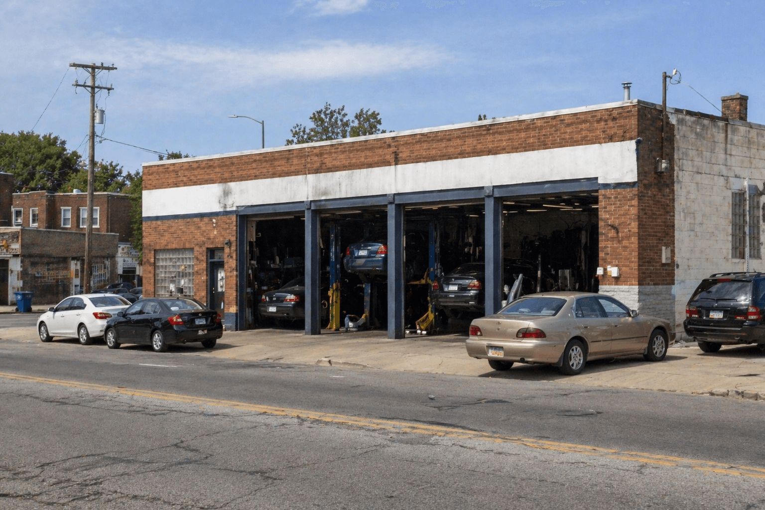 Auto repair shop customer reviewing estimate on a tablet with a mechanic at the service counter