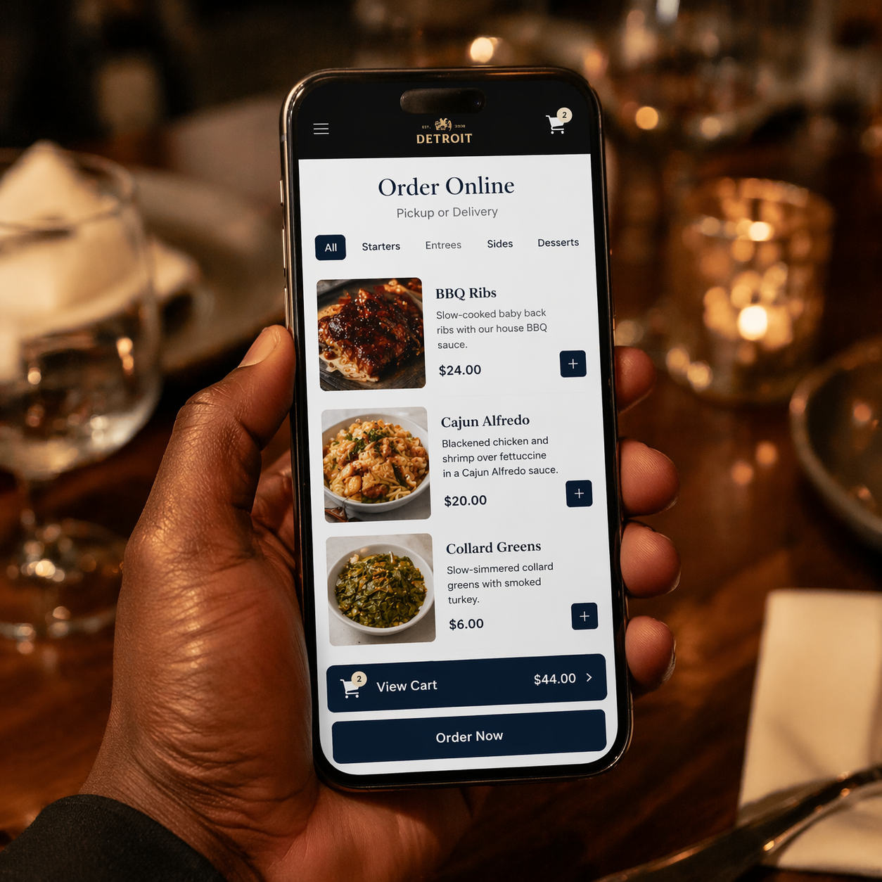 Close-up of a smartphone showing a Detroit restaurant's online ordering page with menu items and cart