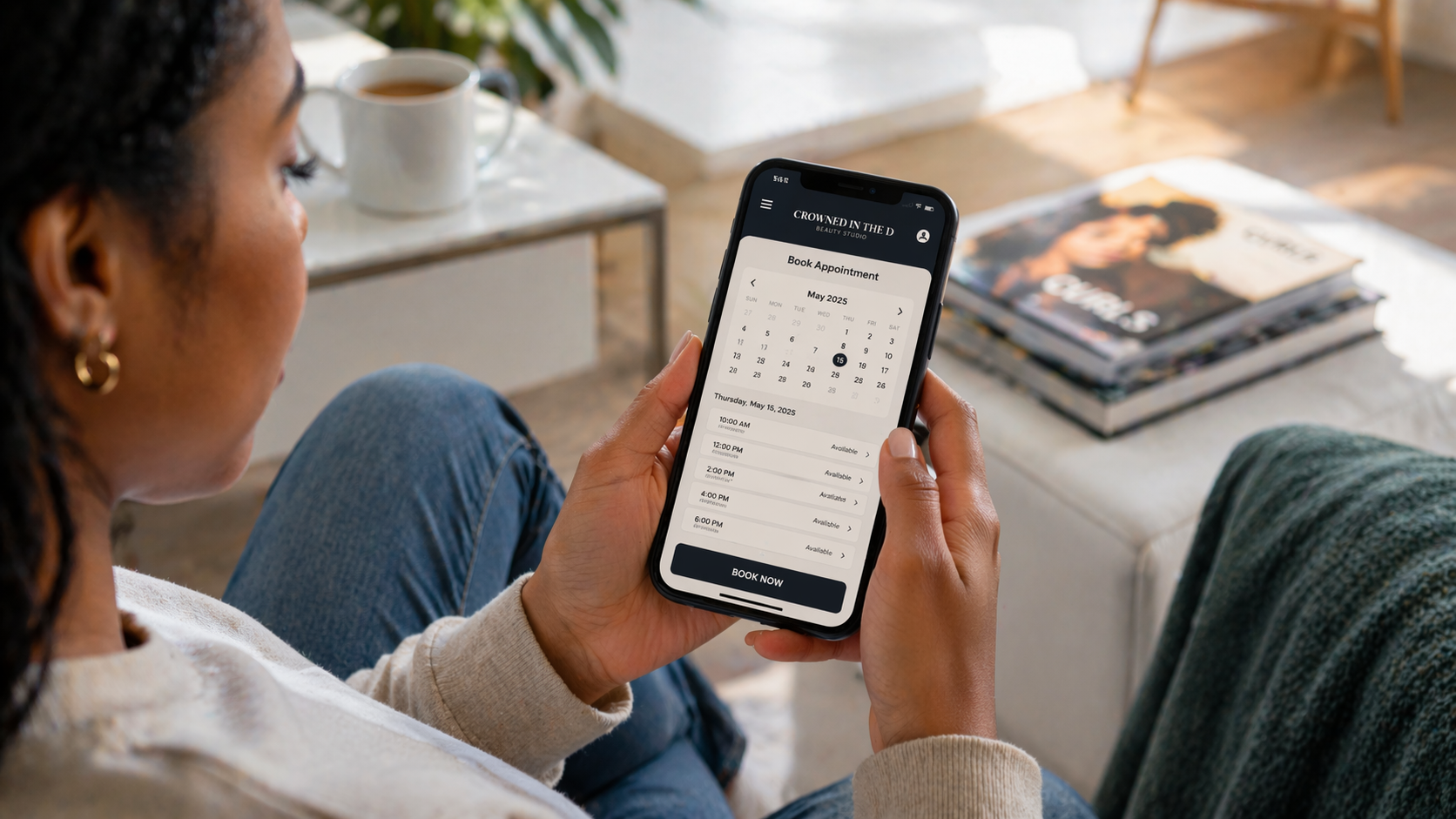 Black female salon owner at a modern reception desk reviewing a fully booked weekly schedule on a tablet, professional Detroit salon interior behind her