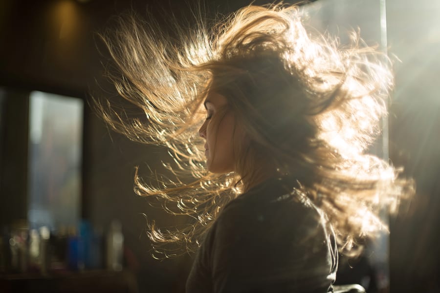 Motion shot of a blowout in progress at Luxe Beauty Studio